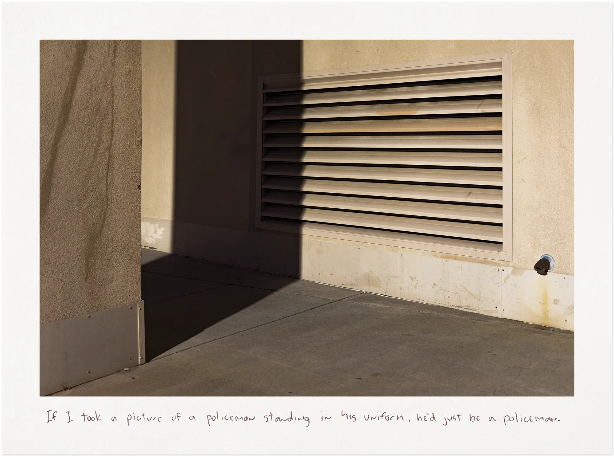 Air vent partially covered by a shadow at night.