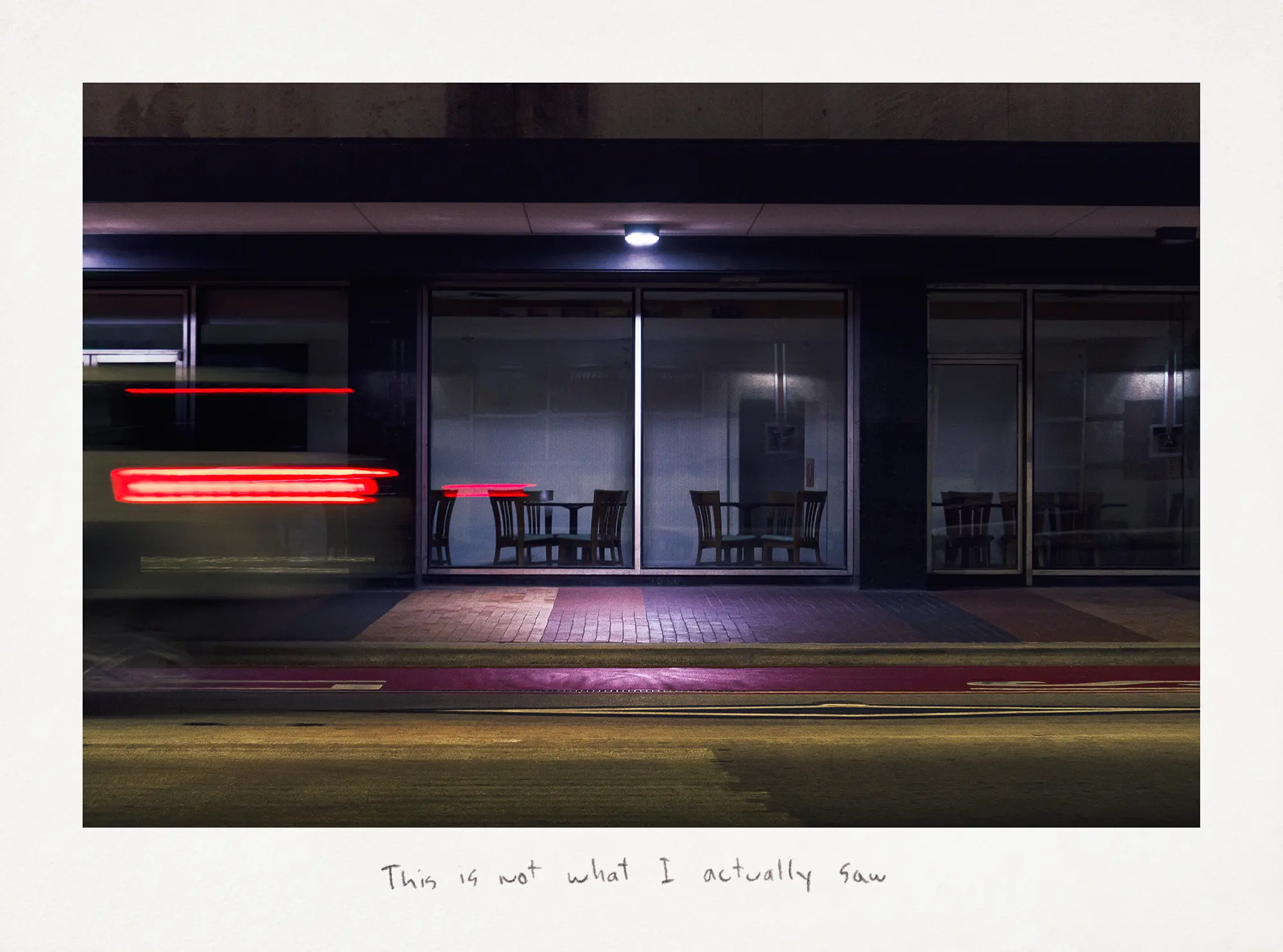 A nighttime photograph shows a diner on a city street while a car passes by. The handwritten caption beneath the image states, "This is not what I actually observed."