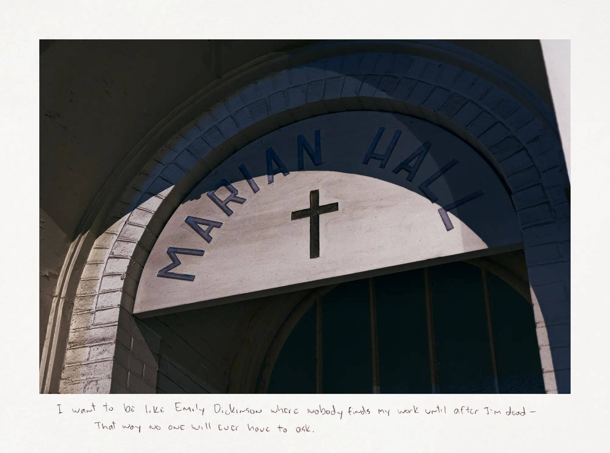 Photograph of a shadow on the white arch above Marian Hall's door.