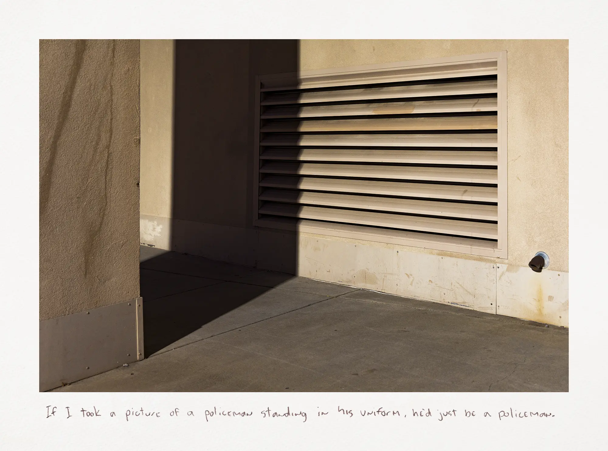 A photograph taken at night showing a dark shadow over a heating vent grate.